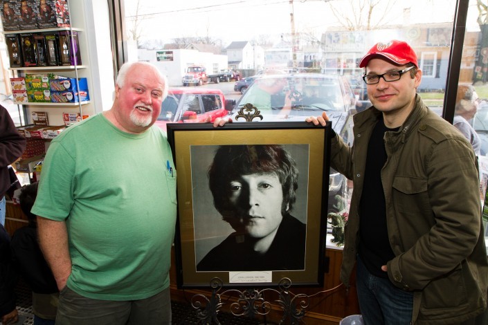 Randy Now, the owner of Man Cave & Consignment Shop, located on 15 Park Street in Bordentown, NJ and Steve Tozzi stand on either side of a portrait of John Lennon signed by the photographer, Richard Avedon. Steve Tozzi is the man behind the documentary documentary film “Riot on the Dance Floor: The Life and Times of Randy Now and City Gardens".